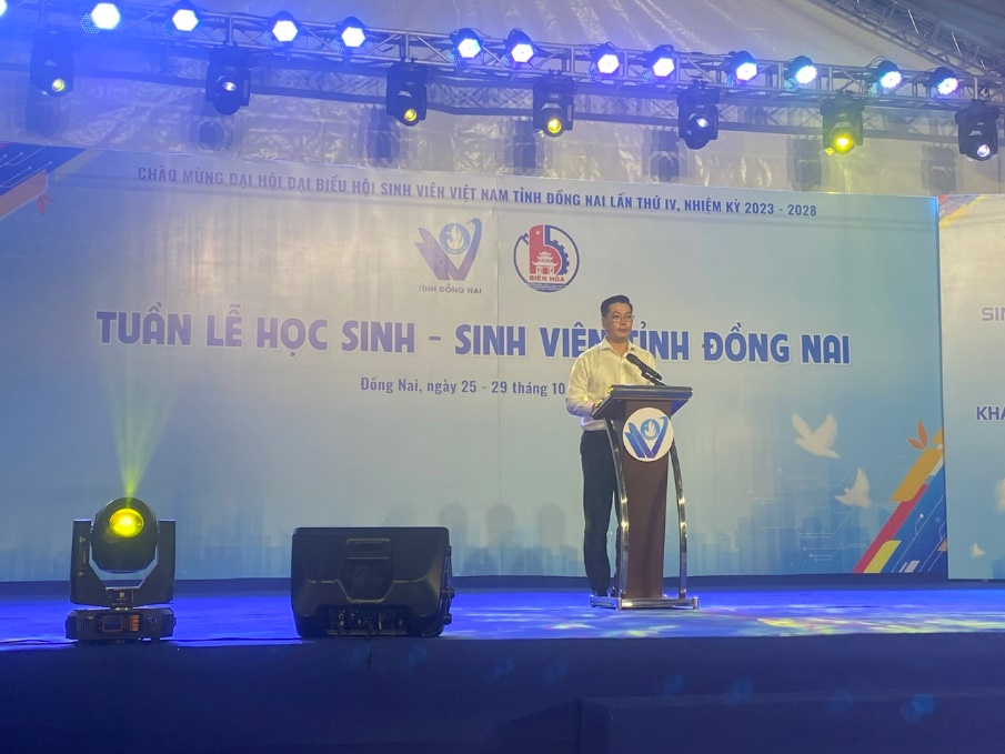 A person standing at a podium with a microphoneDescription automatically generated