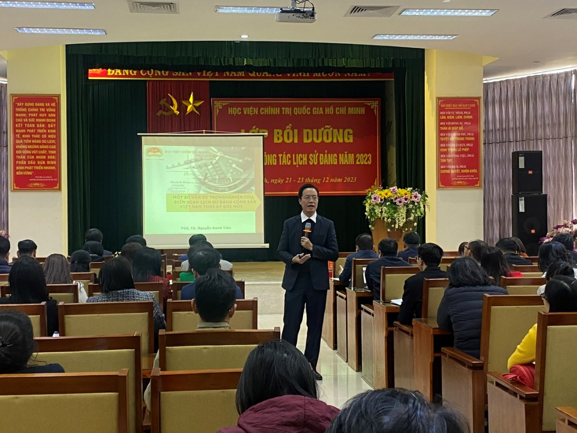 A person standing in front of a group of peopleDescription automatically generated