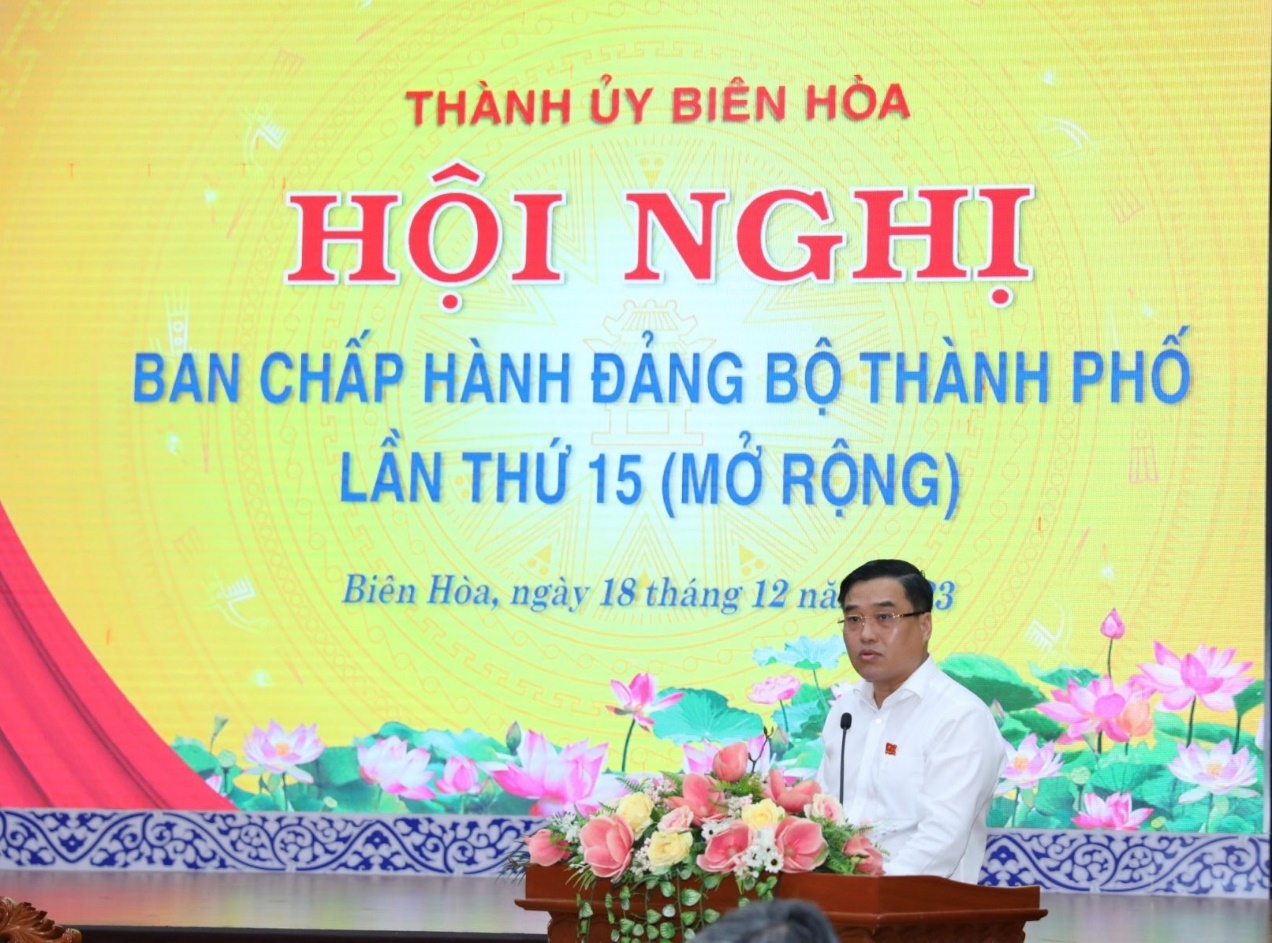 A person standing at a podium with a microphoneDescription automatically generated