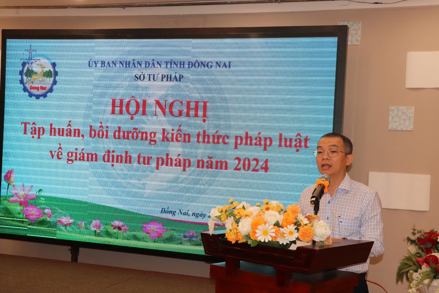 A person standing at a podium with a microphoneDescription automatically generated
