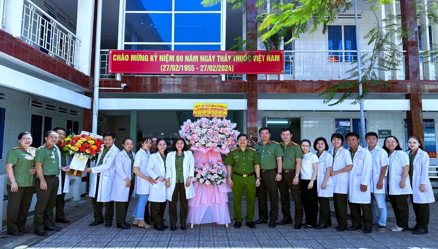 A group of people standing in front of a buildingDescription automatically generated