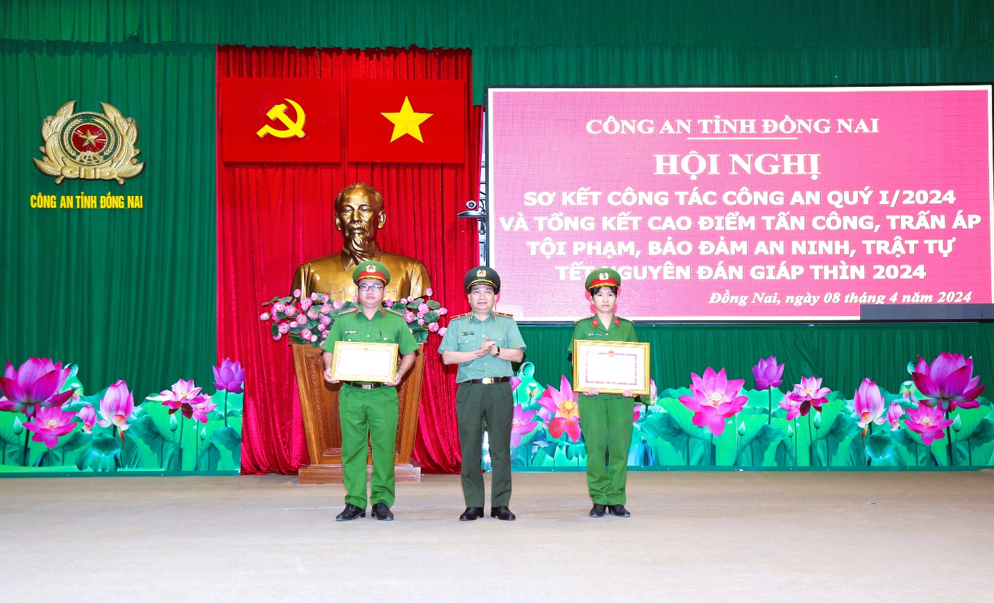 A group of people standing on a stageDescription automatically generated