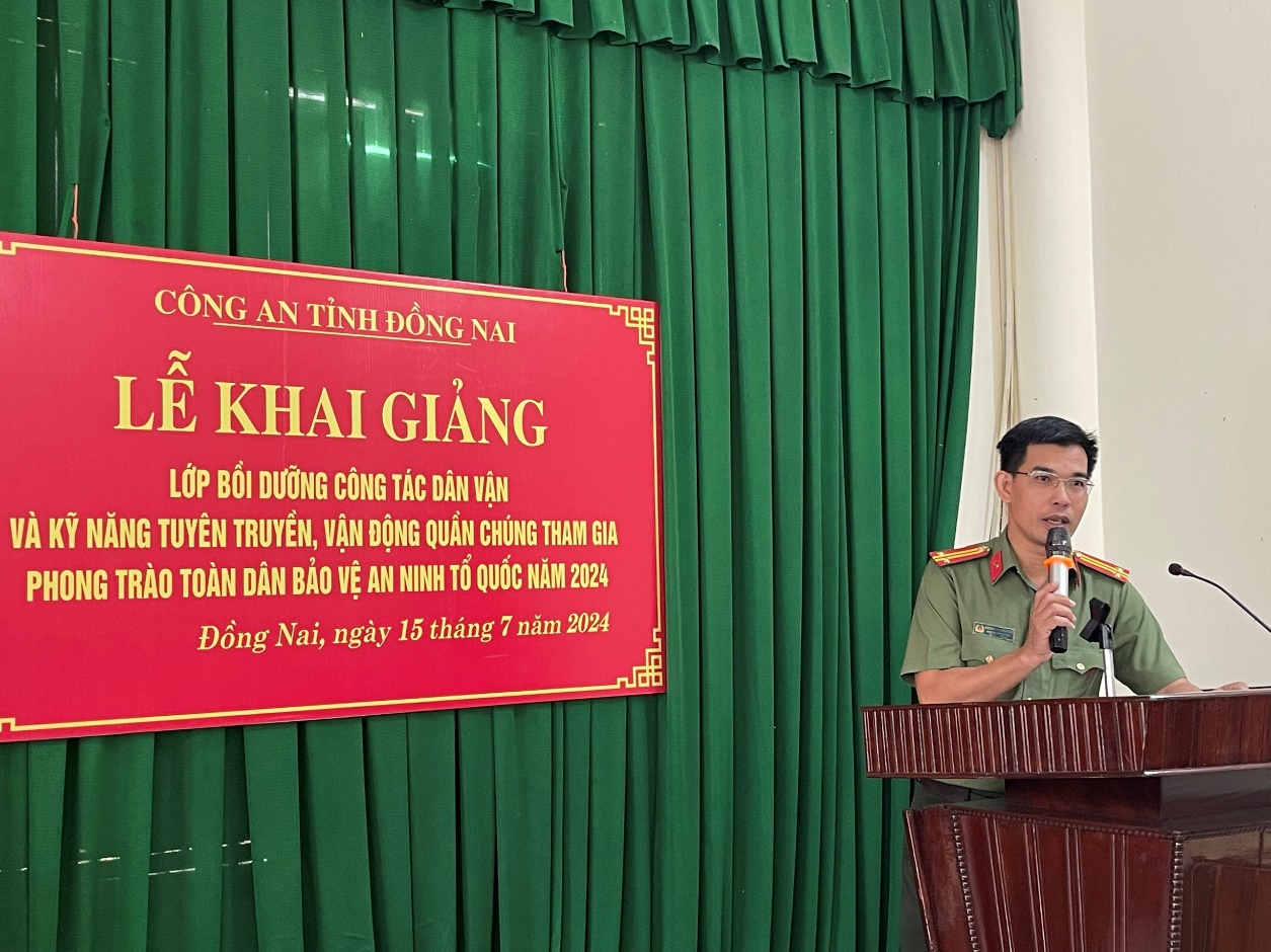 A person in uniform standing at a podium with microphonesDescription automatically generated