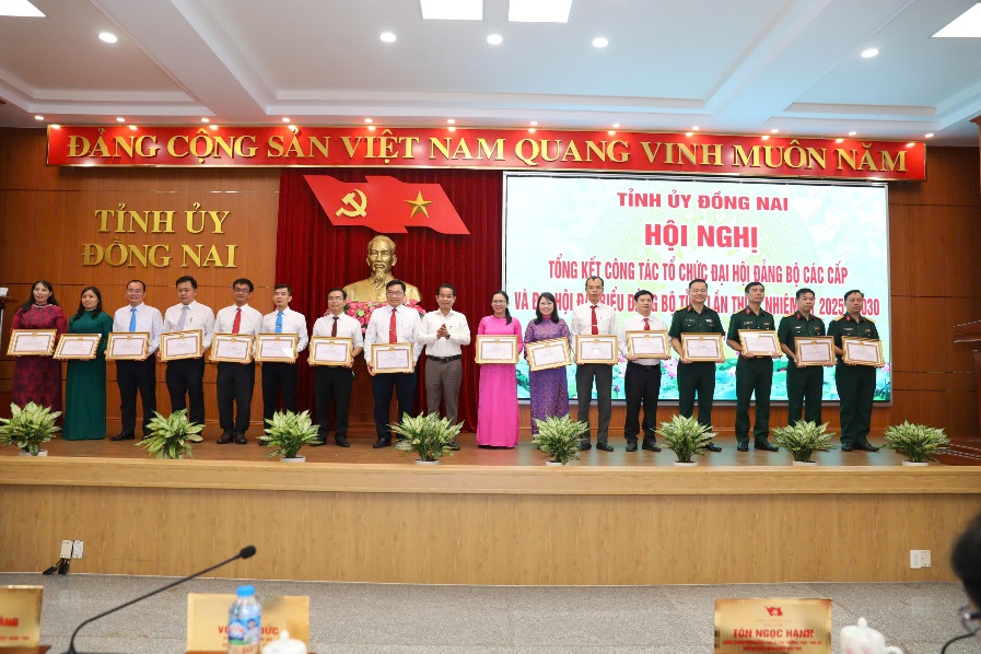 A group of people standing on a stageAI-generated content may be incorrect.