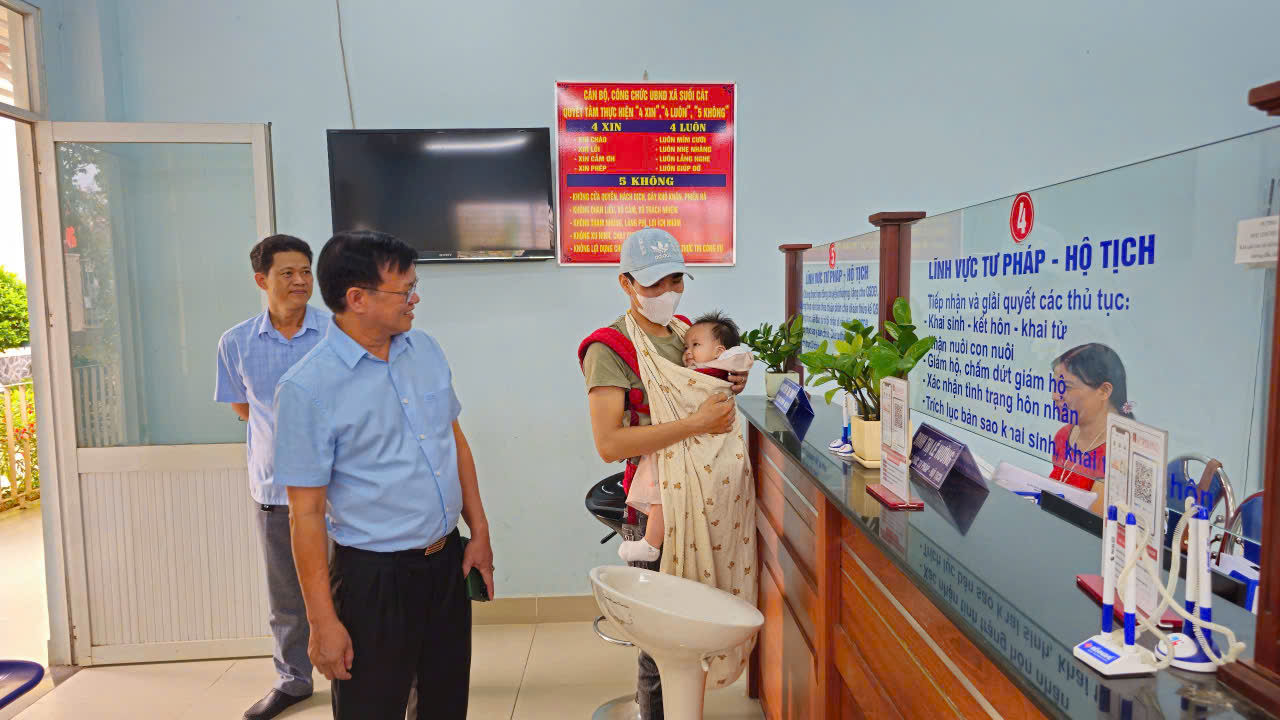 A person holding a babyDescription automatically generated