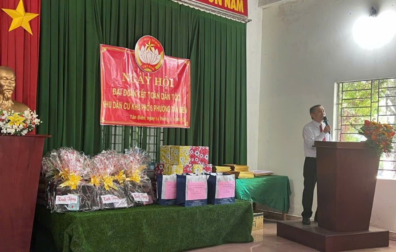 A person standing at a podium with presentsDescription automatically generated