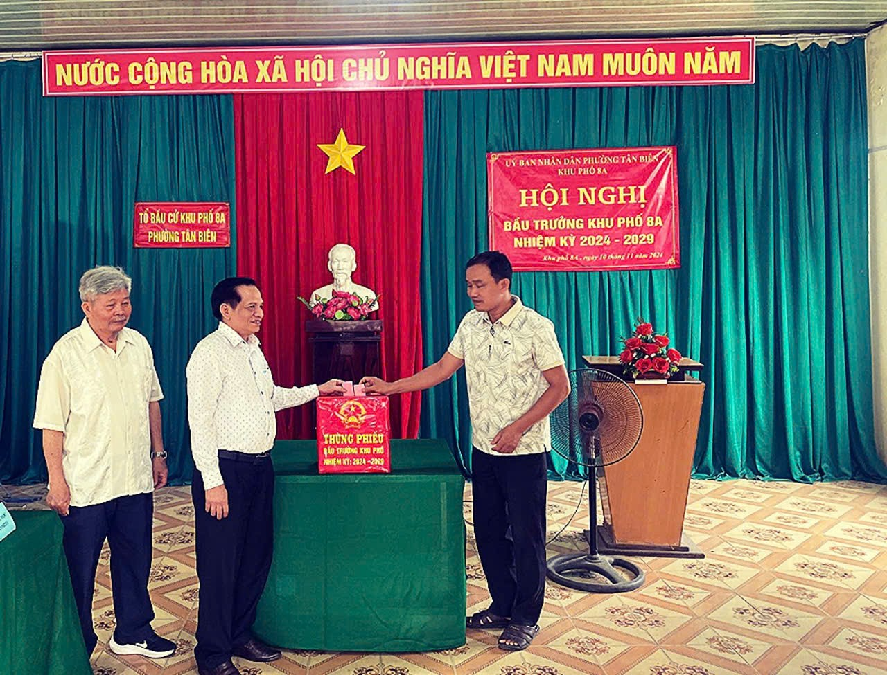 A group of men standing in front of a podiumDescription automatically generated