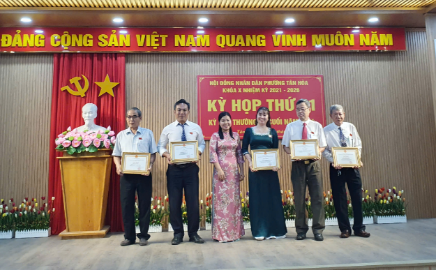 A group of people holding certificatesDescription automatically generated