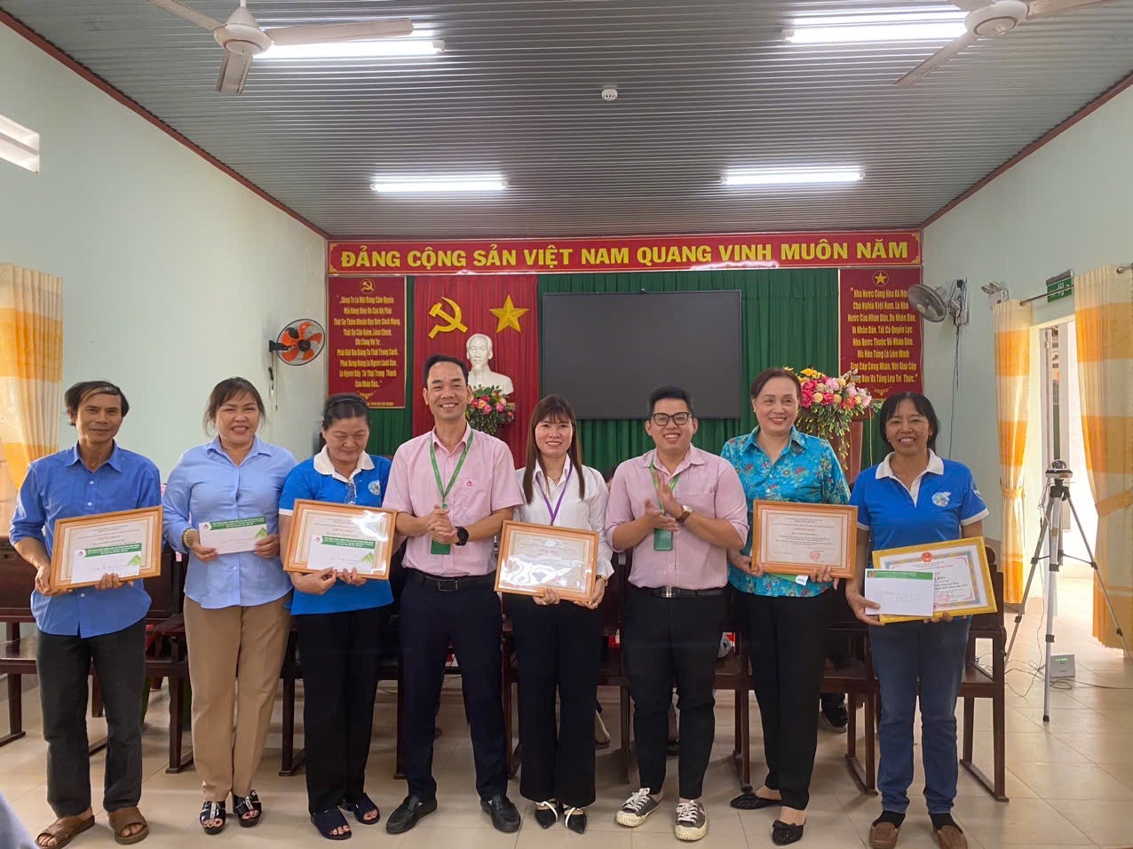 A group of people holding certificates